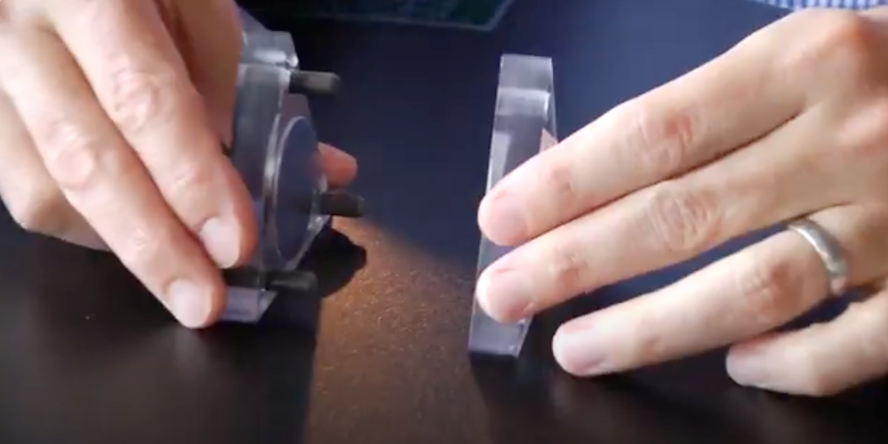 A close-up of hands holding magnets.